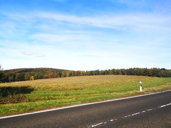 Road amidst field against sky in hungary 