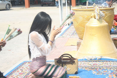 Rear view of woman sitting in store