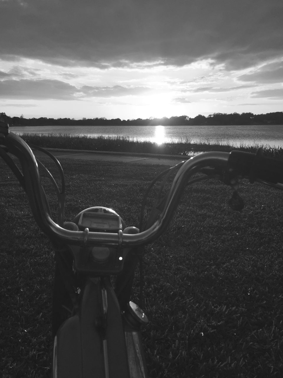 transportation, sky, land vehicle, landscape, mode of transport, cloud - sky, road, field, tranquil scene, tranquility, sunlight, nature, cloud, scenics, car, beauty in nature, bicycle, grass, outdoors, cropped