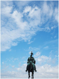 Low angle view of statue against blue sky