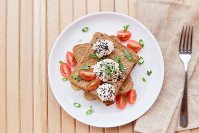 Fresh vegan sandwiches from wholegrain bread, tomatoes, herbs, quinoa and vegan sause