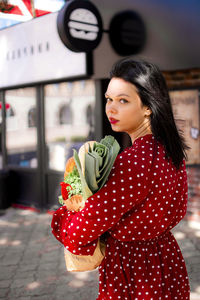 Portrait of young woman using mobile phone