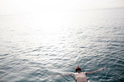 Man floats in ocean in barbados