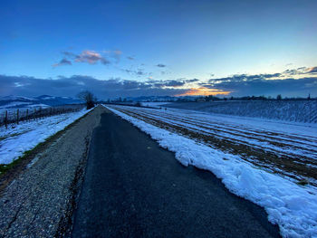 Surface level of road against sky during winter