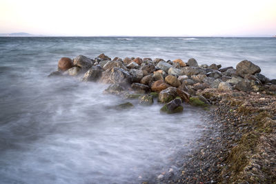 Rocks on beach against sky