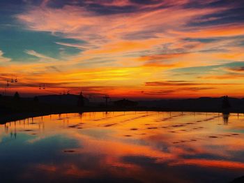 Scenic view of lake against romantic sky at sunset