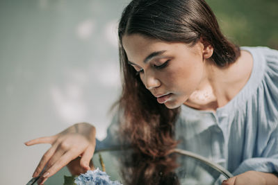 Portrait of young woman looking down