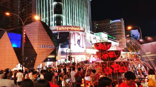 People in illuminated city at night