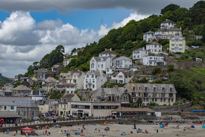 Seaside village against cloudy sky