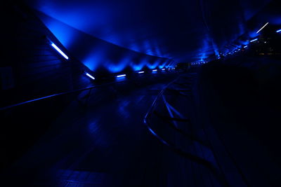 Illuminated tunnel at night