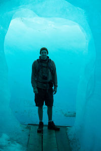 Full length of young man standing in sea