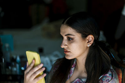 Portrait of young woman using smart phone