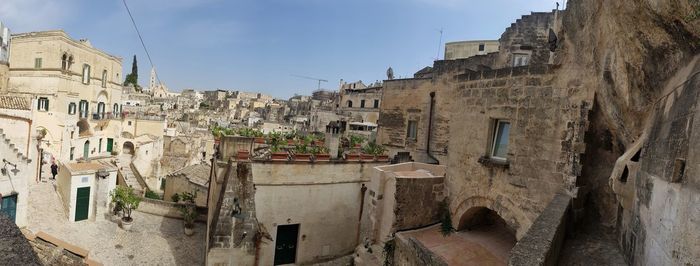 Old buildings in town against sky