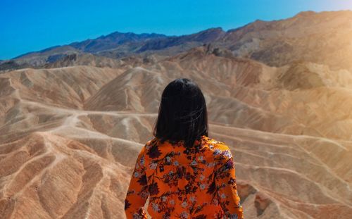 Rear view of woman looking at desert