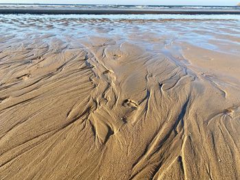 High angle view of wet sand on beach