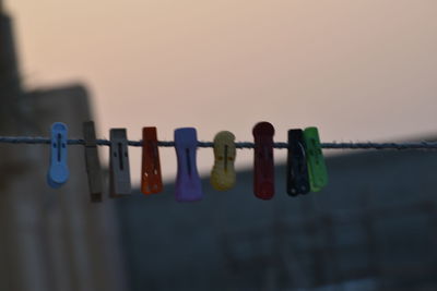 Close-up of clothespins hanging on clothesline