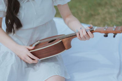 Midsection of woman playing piano