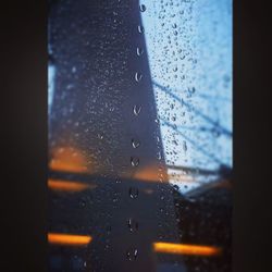 Close-up of waterdrops on glass window with rain drops