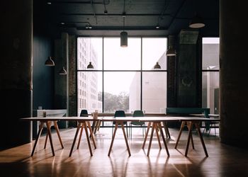 Empty chairs and table in room