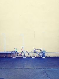 Bicycle parked against wall