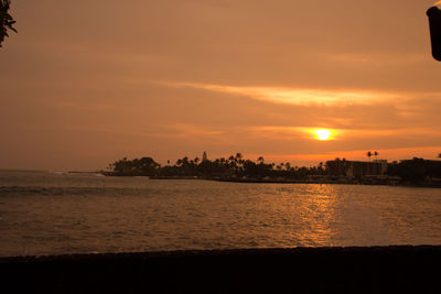 Scenic view of sea against orange sky