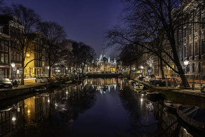 Bridge over canal in city at night