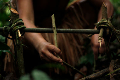 Close-up of man making trap