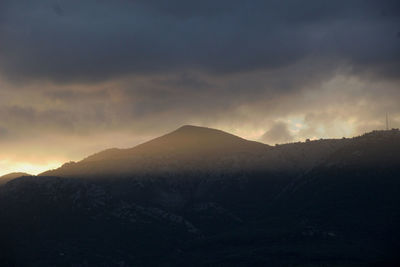 Scenic view of mountains against dramatic sky