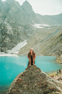 Woman standing on mountain against sky