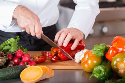 Midsection of chef preparing food on table