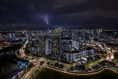 High angle view of illuminated cityscape against sky at night