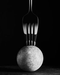 Close-up of apple on table against black background