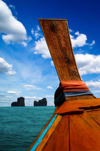 Wooden post in sea against sky