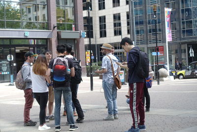 People walking on sidewalk in city