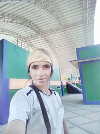 Portrait of beautiful woman standing against ceiling