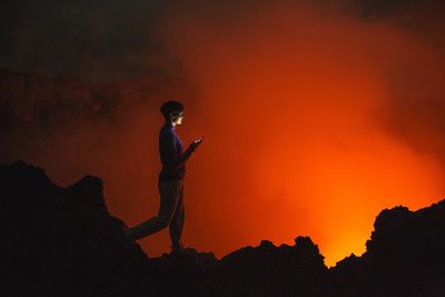 Woman looking at volcanic eruption