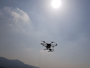 Low angle view of helicopter against sky