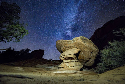 Rock formation against sky at night