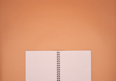Close-up of book on table against orange background
