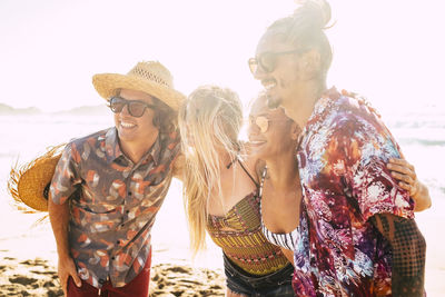 Happy friends enjoying on shore at beach