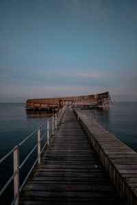 Pier over sea against sky