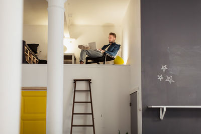 Young man sitting on the wall