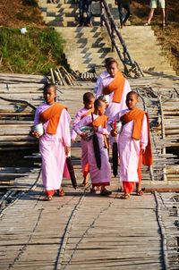 Rear view of people standing outdoors