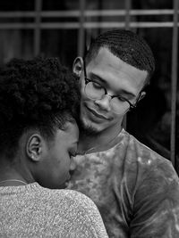 Portrait of young couple kissing outdoors