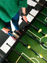 High angle view of woman playing foosball 