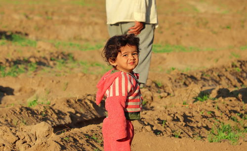 An indian young child went to see the crop grown in his field during the winter with grandfather