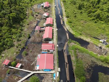 High angle view of road amidst trees on field