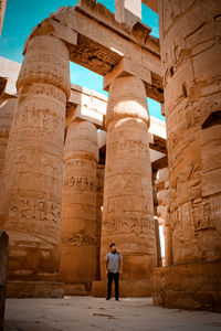 Full length of man standing in front of historical egyptian building