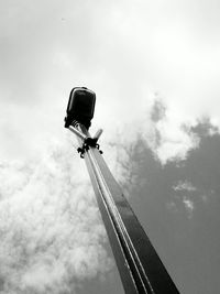 Low angle view of street light against cloudy sky