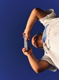 Cropped image of woman holding hands over black background